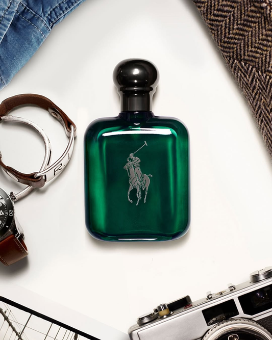 Green Ralph Lauren cologne bottle on a white surface with accessories.